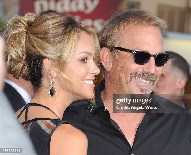 Actor Kevin Costner and wife Christine Baumgartner attend the premiere of Summit Entertainment's 'Draft Day' presented by Bud Light at the Regency...