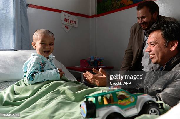 In this photograph taken on April 6 Abuzar Ahmad, the youngest son of slain Afghan AFP reporter Sardar Ahmad, plays during a visit by his uncle...
