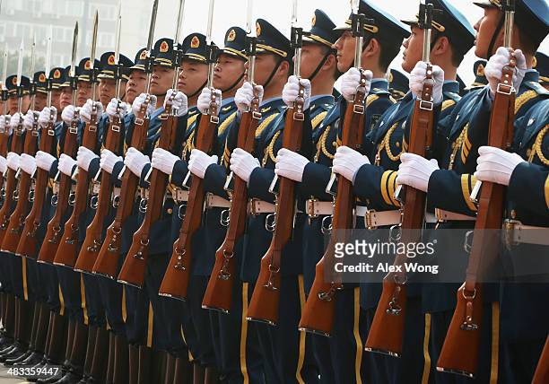 Chinese honor guards stand to attention as they are reviewed by U.S. Secretary of Defense Chuck Hagel during a welcome ceremony at the Chinese...