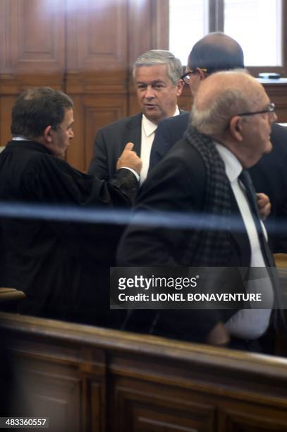 Jean-Marie Messier , former chief executive officer of French multinational media conglomerate Vivendi, speaks to a lawyer at the Paris courthouse...