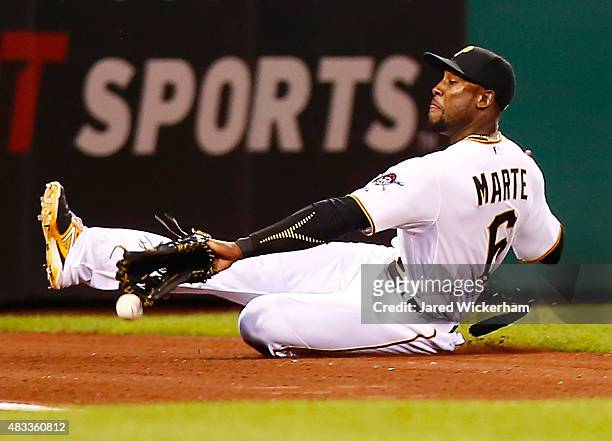 Starling Marte of the Pittsburgh Pirates slides but comes up short on a catch in left field against the Los Angeles Dodgers during the game at PNC...