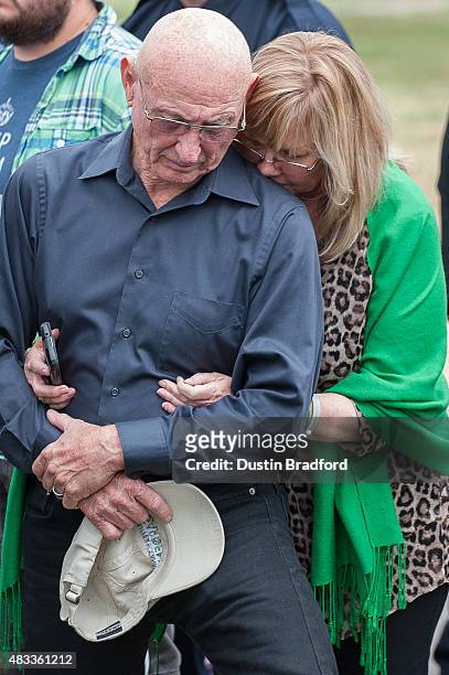 Sandy and Lonnie Phillips, the parents of Jessica Ghawi, a victim of the Aurora, Colorado theater shooting, comfort each other during a press...
