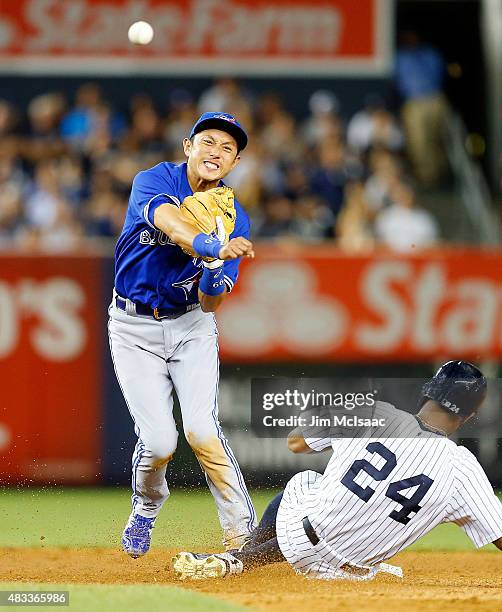 Munenori Kawasaki of the Toronto Blue Jays completes a ninth inning double play after forcing out Chris Young of the New York Yankees at Yankee...