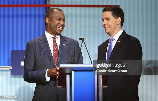 Republican presidential candidates Ben Carson and Wisconsin Gov. Scott Walker chat during the first Republican presidential debate hosted by Fox News...