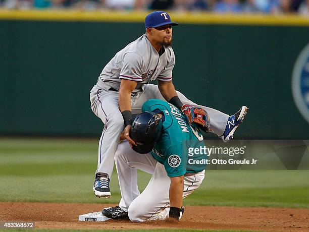 Jesus Montero of the Seattle Mariners is put out by second baseman Rougned Odor of the Texas Rangers to end the second inning at Safeco Field on...