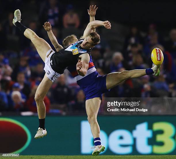 Hamish Hartlett of the Power and Lachie Hunter of the Bulldogs competes for the ball during the round 19 AFL match between the Western Bulldogs and...