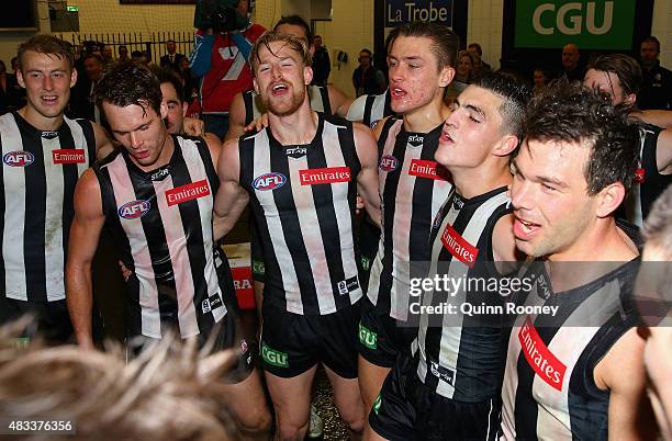 Matt Scharenberg, Jonathon Marsh, Darcy Moore, Brayden Maynard and Levi Greenwood of the Magpies sing the song in the rooms after winning the round...