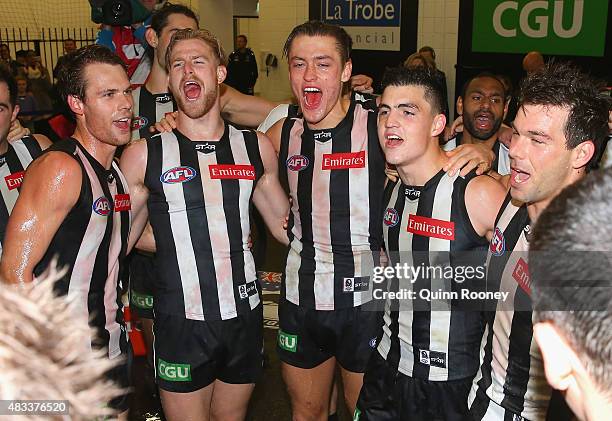 Matt Scharenberg, Jonathon Marsh, Darcy Moore, Brayden Maynard and Levi Greenwood of the Magpies sing the song in the rooms after winning the round...