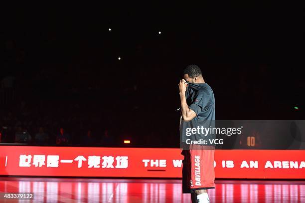 American basketball player Tracy McGrady wipes the tears while announcing his retirement before the friendly match between NBDL and Shanghai Grate...