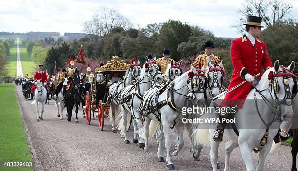 Irish President Michael D Higgins and Queen Elizabeth II arrive in a state carriage at Windsor Castle, on April 8, 2014 in Windsor, England. This is...