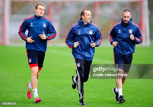 Holger Badstuber and Diego Contento of FC Bayern Muenchen in action during a training session ahead of their UEFA Champions League quarter-final...