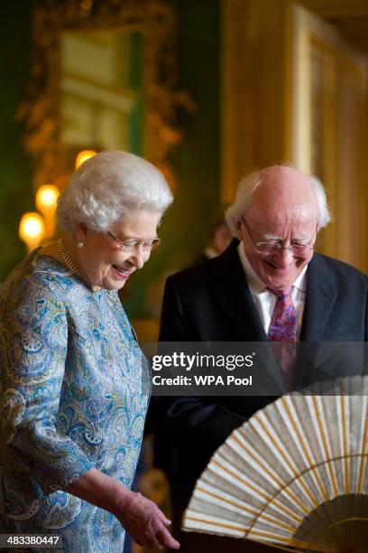 Queen Elizabeth II shows Irish President Michael D Higgins Irish related items from the Royal Collection, in the Green Drawing Room at Windsor Castle...