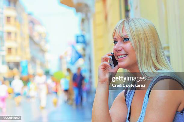 young woman smiling talking on mobile phone - knez mihailova street stock pictures, royalty-free photos & images