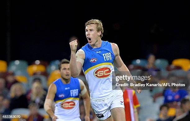 Tom Lynch of the Suns celebrates a goal during the round 19 AFL match between the Brisbane Lions and the Gold Coast Suns at The Gabba on August 8,...