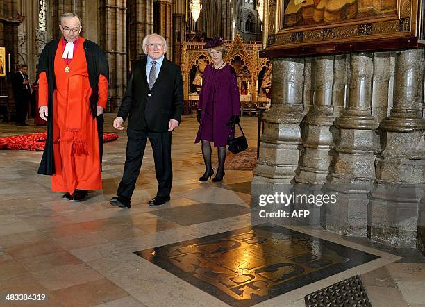 The Very Reverend John Hall, Dean of Westminster Abbey , Irish President Michael D. Higgins and his wife Sabina , walk up to the floor memorial to...