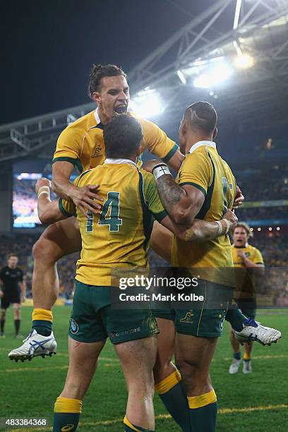 Adam Ashley-Cooper, Matt Toomua and Israel Folau of the Wallabies celebrate after Adam Ashley-Cooper scored a try during The Rugby Championship match...