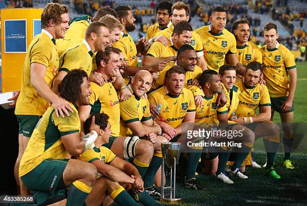 The Wallabies pose after winning the Rugby Championship trophy during The Rugby Championship match between the Australia Wallabies and the New...