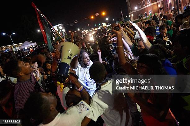 Protestors demonstrate outside the Ferguson Police Department in Ferguson, Missouri on August 7, 2014. As the embattled community celebrates the one...