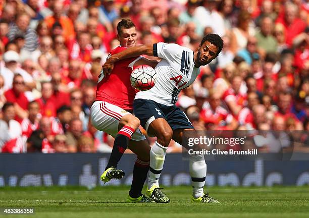 Morgan Schneiderlin of Manchester United and Mousa Dembele of Tottenham Hotspur compete for the ball during the Barclays Premier League match between...