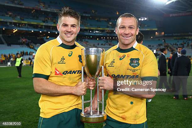 Drew Mitchell and Matt Giteau of the Wallabies pose with the Rugby Championship trophy after winning the Rugby Championship match between the...