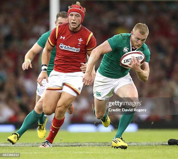 Keith Earls of Ireland breaks with the ball to score a try during the International match between Wales and Ireland at the Millennium Stadium on...