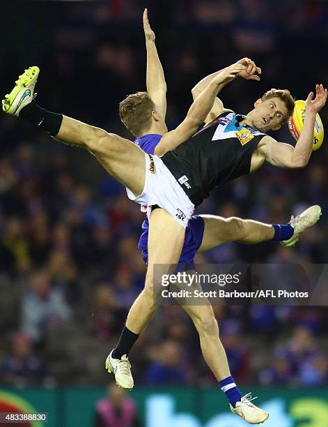 Hamish Hartlett of Port Adelaide and Lachie Hunter of the Western Bulldogs compete for the ball during the round 19 AFL match between the Western...