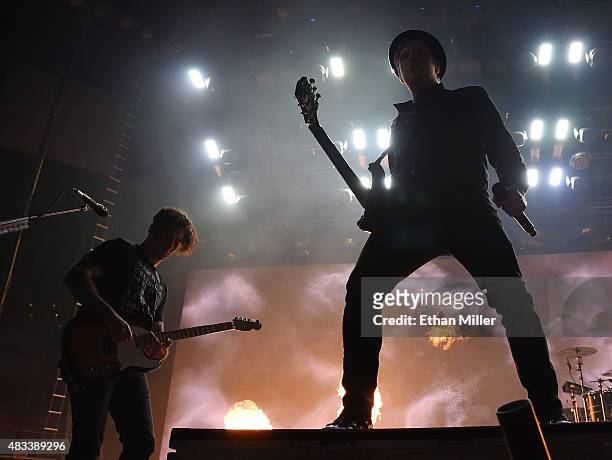Guitarist Joe Trohman and frontman Patrick Stump of Fall Out Boy are silhouetted as they perform at the Mandalay Bay Events Center during a stop of...