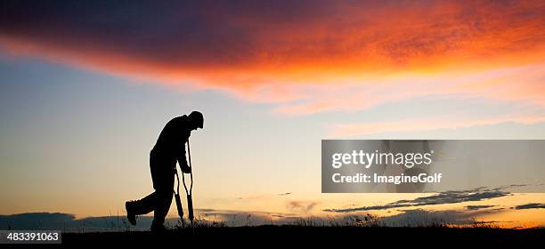 silhouette of a senior man with crutches - man crutches stock pictures, royalty-free photos & images