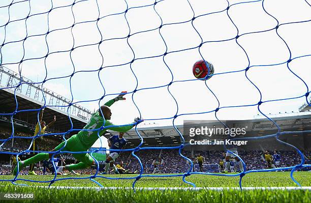 Miguel Layun of Watford scores the opening goal past Tim Howard of Everton during the Barclays Premier League match between Everton and Watford at...