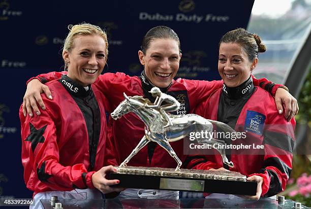The Girls Team of Sammy Jo Bell, Emma-Jayne Wilson and Hayley Turner celebrate their victory with the Shergar Cup during the Dubai Duty Free Shergar...