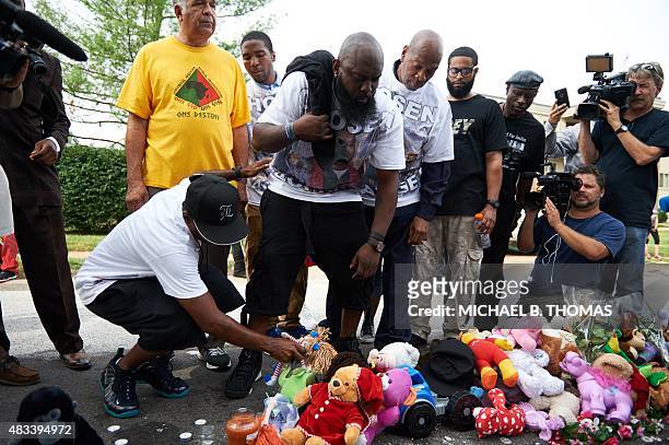 Michael Brown Sr., father of slain 18 year-old Michael Brown Jr. Looks at placed stuffed animals along with Brown family members prior to a march of...