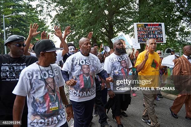 Michael Brown Sr., father of slain 18 year-old Michael Brown Jr. Holds hands along with Brown family members during a march of solidarity on August...