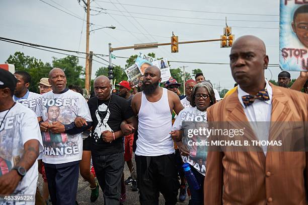 Michael Brown Sr., father of slain 18 year-old Michael Brown Jr. Holds hands along with Brown family members during a march of solidarity on August...