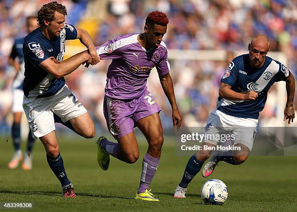 Nick Blackman of Reading holds off pressure from Jonathan Spector and David Cotterill of Birmingham during the Sky Bet Championship match between...