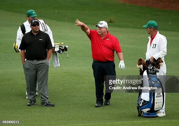 Craig Stadler of the United States chats with his son Kevin during a practice round prior to the start of the 2014 Masters Tournament at Augusta...
