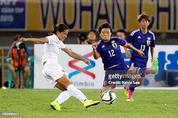Rika Masuya of Japan challenges Wang Fei of China PR during the EAFF East Asian Cup 2015 final round at the Wuhan Sports Center Stadium on August 8,...