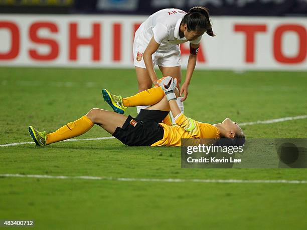 Wang Fei of China PR lies on the ground after a collision at EAFF East Asian Cup 2015 final round between China PR and Japan at the Wuhan Sports...