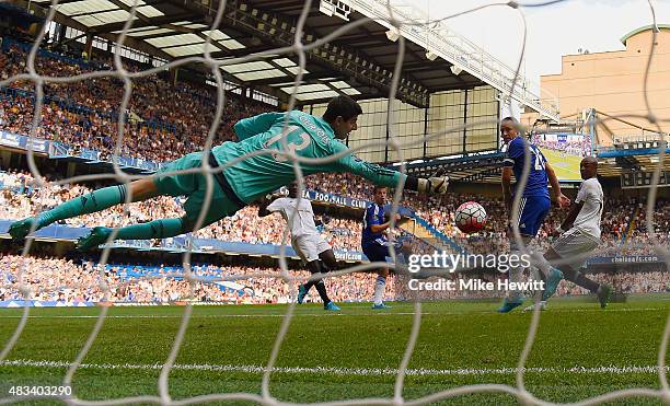 Thibaut Courtois of Chelsea makes a save from Bafetibis Gomis of Swansea City during the Barclays Premier League match between Chelsea and Swansea...