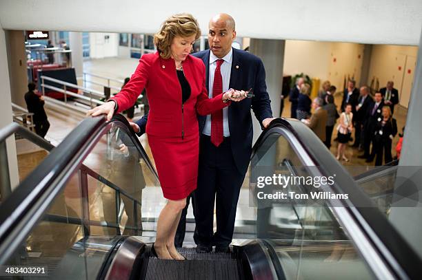 Sens. Kay Hagan, D.N.C., and Cory Booker, D-N.J., make their way through the basement of the Capitol while en route to the senate luncheons.