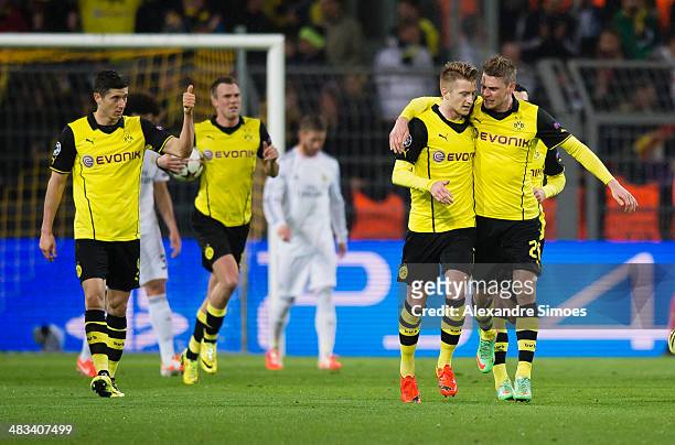 Marco Reus of Borussia Dortmund celebrates scoring the opening goal together with his team mate Lukasz Piszczek during the UEFA Champions League...