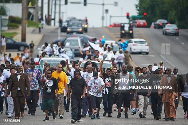 Michael Brown Sr., father of slain 18 year-old Michael Brown Jr., takes stuffed animals to a makeshift memorial prior to a march of solidarity in...