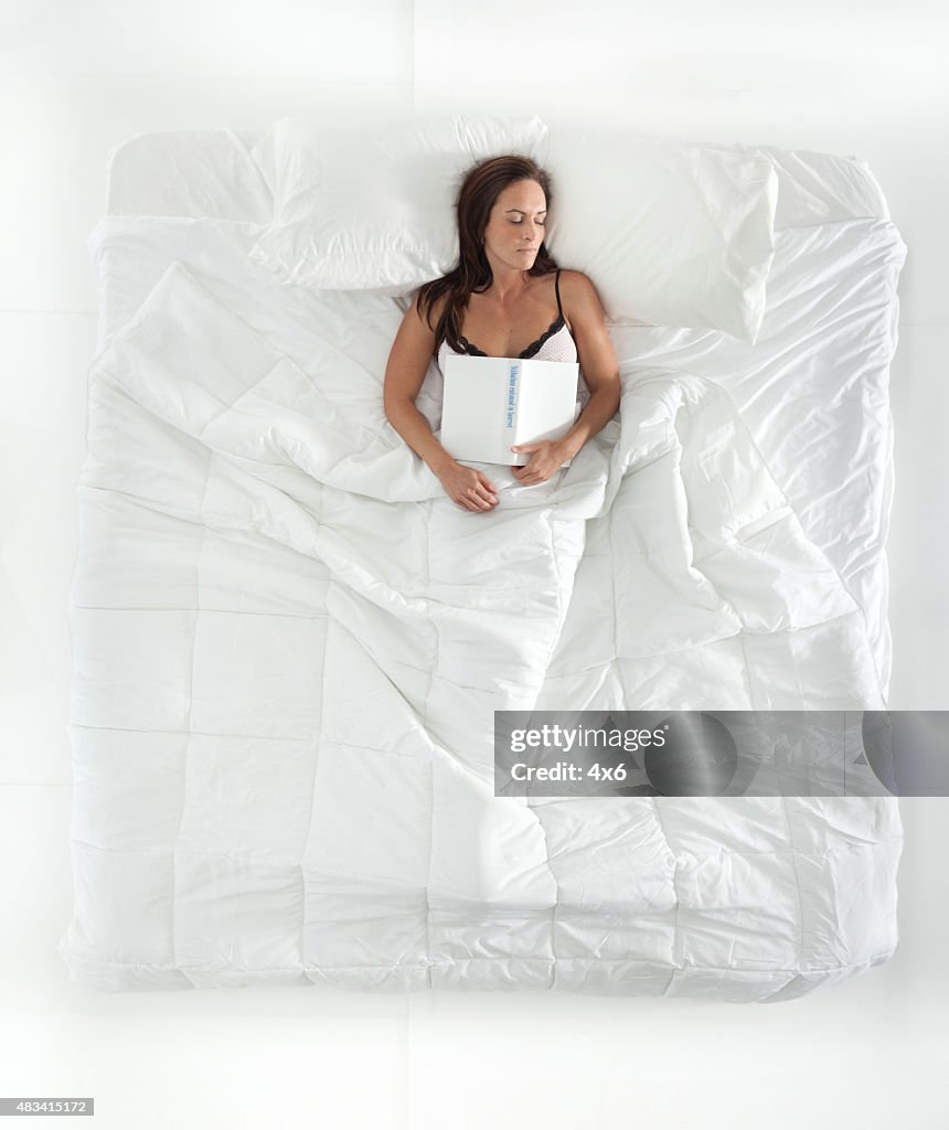 Above view of woman sleeping on bed