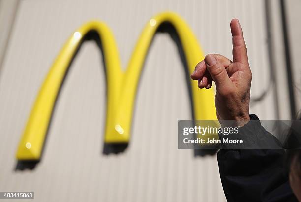 An activist protests for higher wages outside a McDonald's restaurant on April 8, 2014 in Stamford, Connecticut. Demonstrations were organized across...