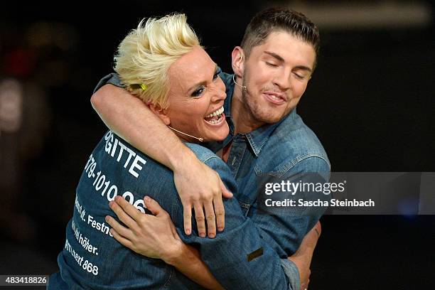 Joey Heindle hugs winner Brigitte Nielsen during the final of the television show 'Ich bin ein Star - lasst mich wieder rein!' on August 8, 2015 in...