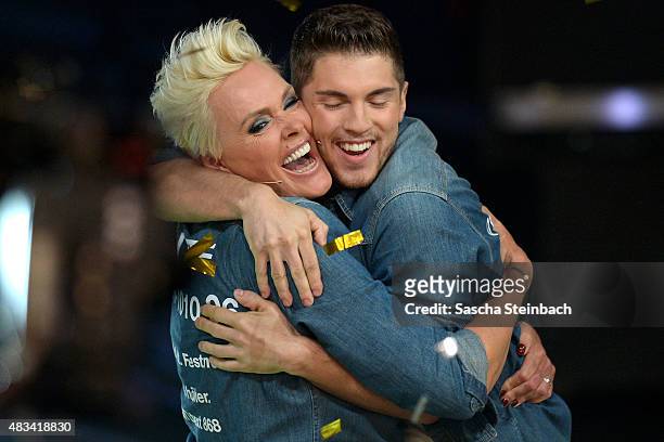 Joey Heindle hugs winner Brigitte Nielsen during the final of the television show 'Ich bin ein Star - lasst mich wieder rein!' on August 8, 2015 in...