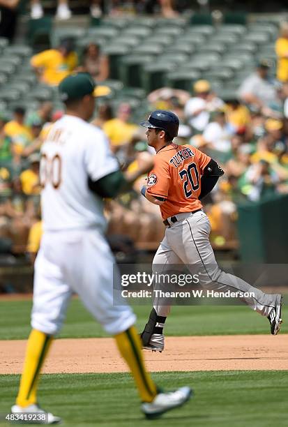 Preston Tucker of the Houston Astros trots around the bases after hitting a solo home run off of Jesse Chavez of the Oakland Athletics in the top of...