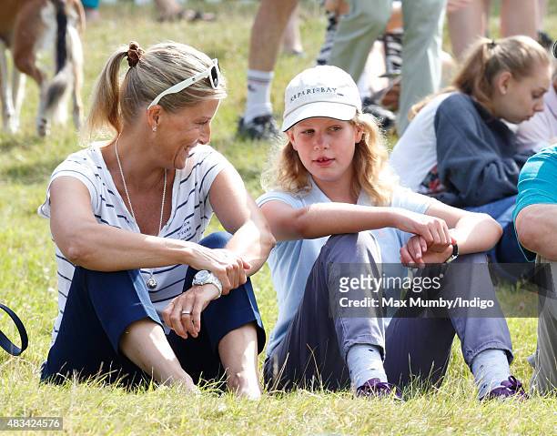 Sophie, Countess of Wessex and daughter Lady Louise Windsor sit on the grass to watch the cross country phase of the competition as they attend day 2...
