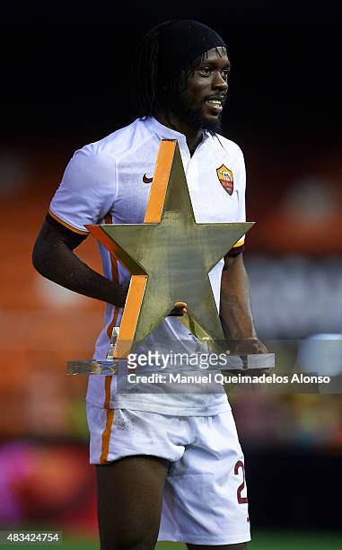 Gervinho of Roma poses with the best palyer trophy before the pre-season friendly match between Valencia CF and AS Roma at Estadio Mestalla on August...