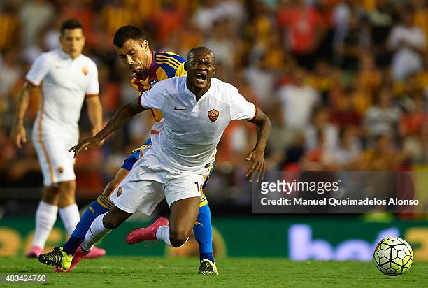 Maicon of Roma is tackled by Javi Fuego of Valencia during the pre-season friendly match between Valencia CF and AS Roma at Estadio Mestalla on...
