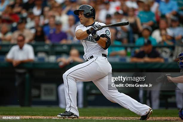 Jesus Montero of the Seattle Mariners hits an RBI single in the fourth inning against the Texas Rangers at Safeco Field on August 8, 2015 in Seattle,...